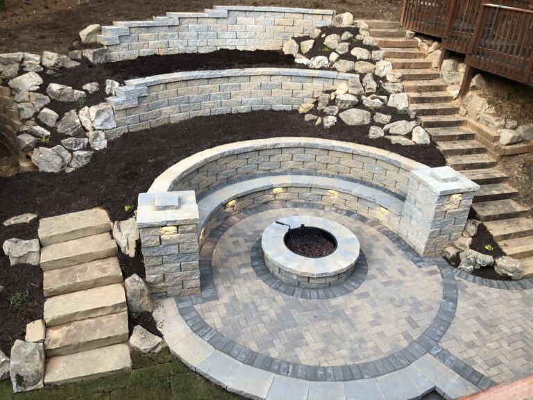 Fire pit and outdoor living area with stone retaining wall and steps by Stone Edge Landscapes, North West Georgia