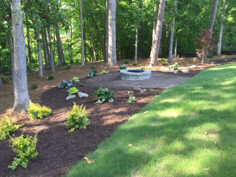 Fire pit and outdoor living area with landscape plantings by Stone Edge Landscapes, North West Georgia