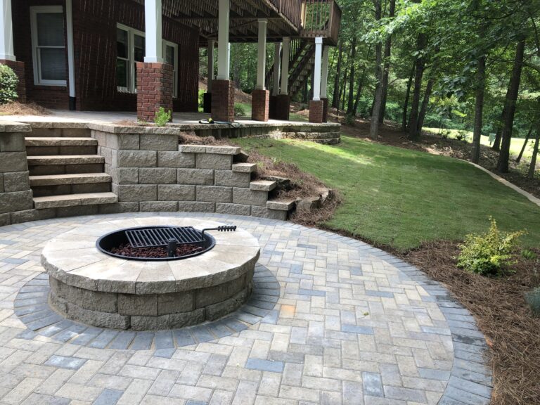 Fire pit and outdoor living area with stone retaining wall and steps by Stone Edge Landscapes, North West Georgia